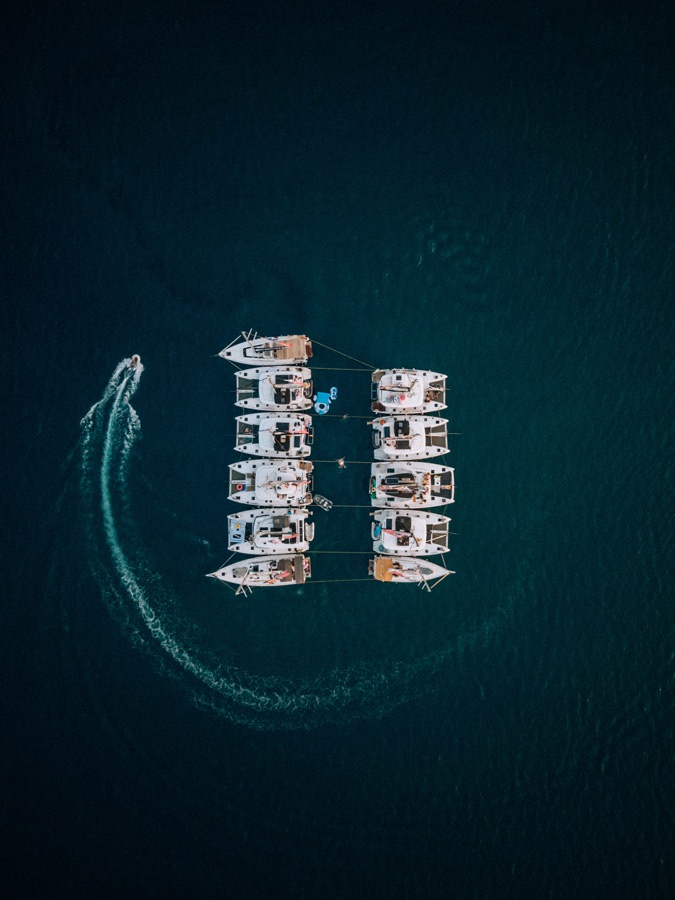 Raw aerial photograph of a Yacht Week flotilla raft-up in Greece